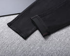 Solid Black Wash Embossed Monogram Jeans V260815