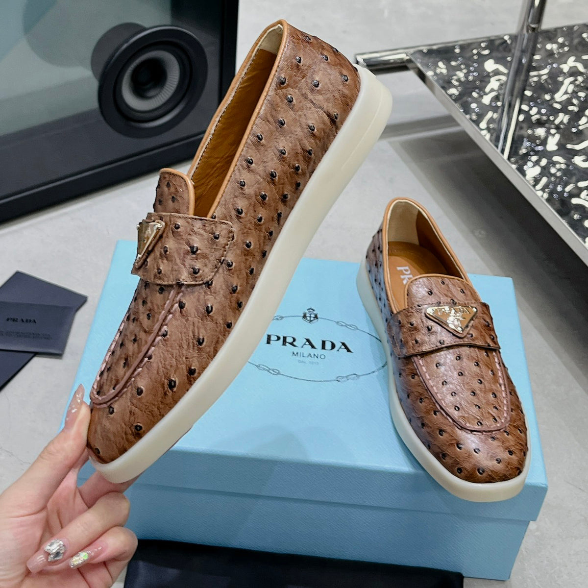Ostrich Grain Metal Triangle Badge Slip-On Loafers S283422