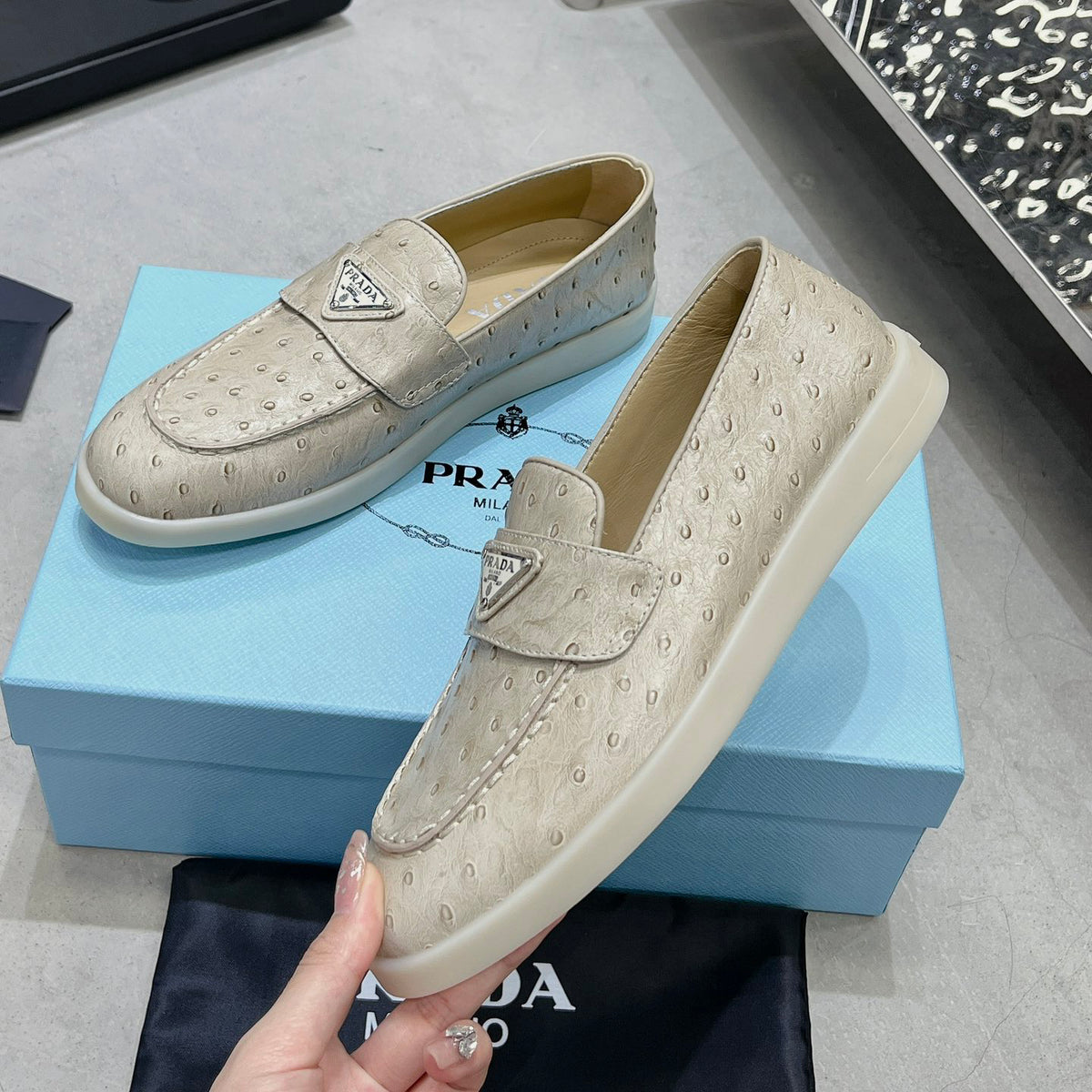 Ostrich Grain Metal Triangle Badge Slip-On Loafers S283422