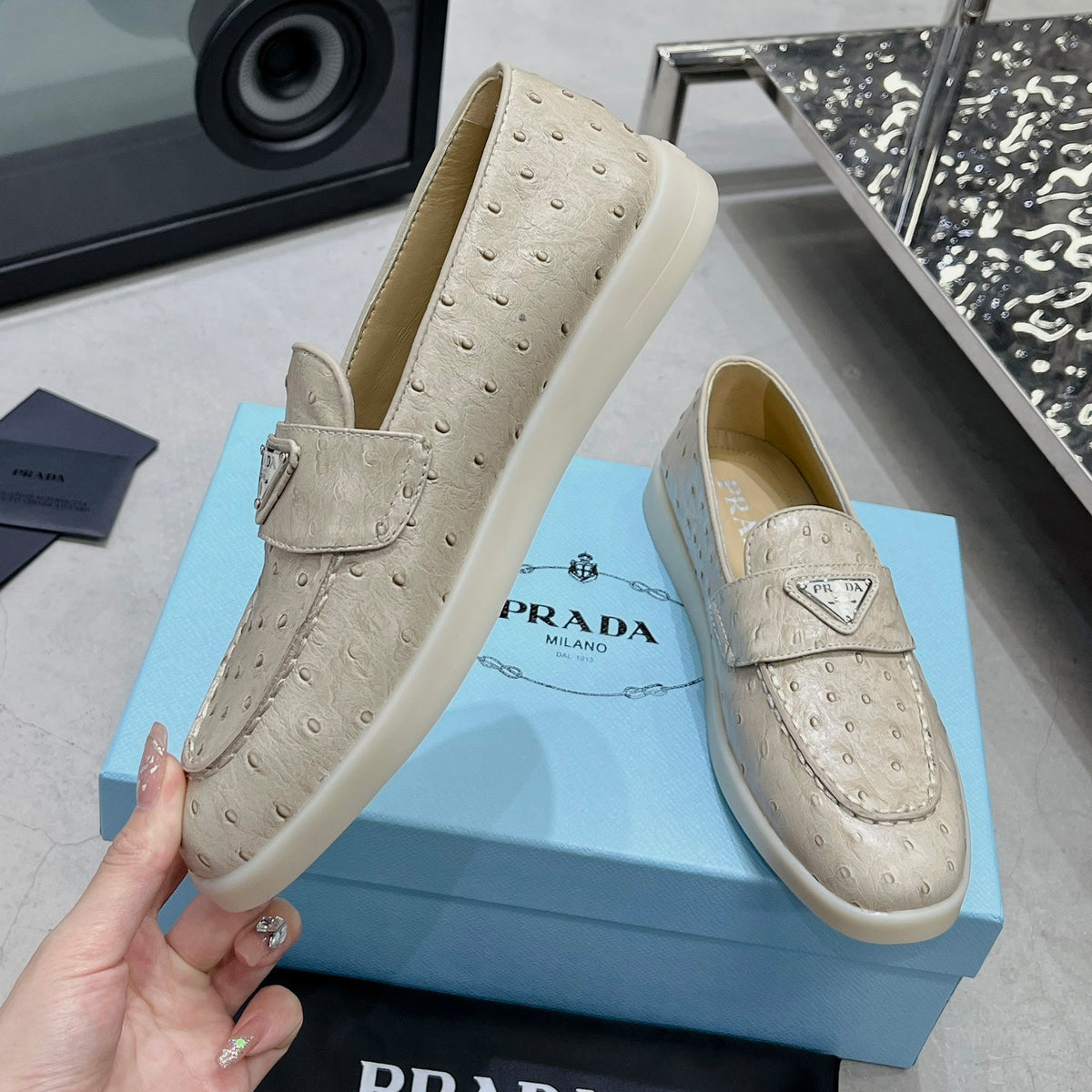 Ostrich Grain Metal Triangle Badge Slip-On Loafers S283422